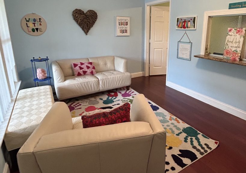 A living room with two couches and a rug